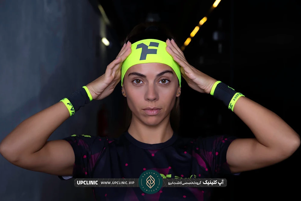 دختری که هدبند سبز به سر خود می بندد